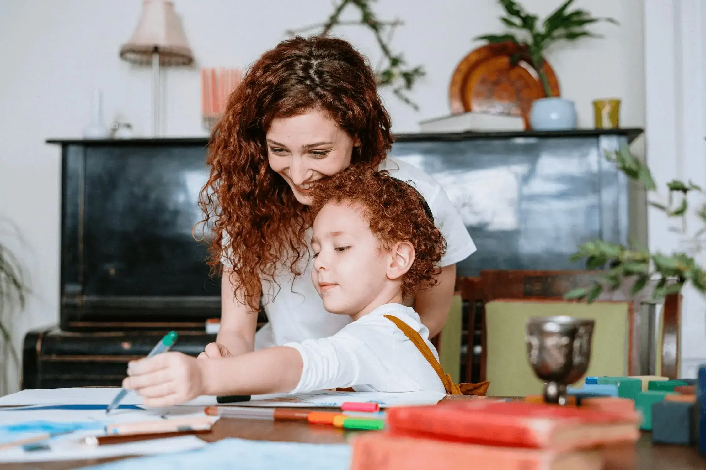 Mother and son coloring at a table